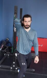 Dr. John using his a band to stretch through the triceps, pec, and lats to improve shoulder mobility